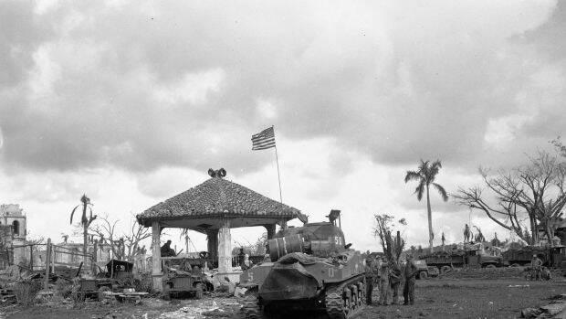 Guam during World War Two. This August 1944 file photo shows an American flag atop the first US tank to lead the push to Agana, capital of Guam.  Photo: AP