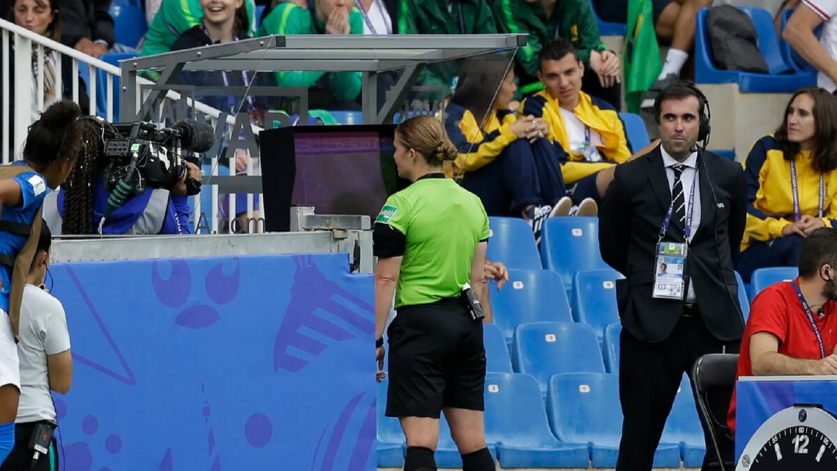 Swiss referee Esther Staubli checks the VAR monitor before awarding Australia's winning goal.