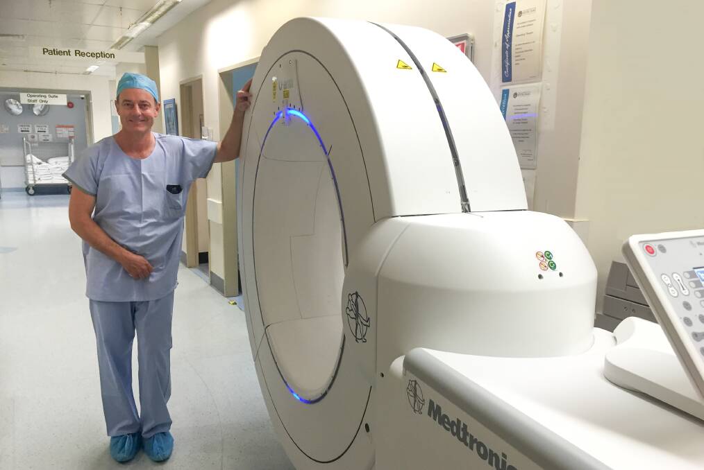 New toy: St George Hospital neurosurgeon Dr Mark Davies next to the portable O-Arm multidimensional surgical imaging system. Picture: Supplied
