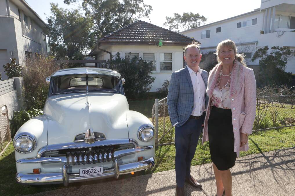 CLASSIC STYLE: Highland Property Agents Melissa Hatheier and Gavin Hill at the property with a classic FJ Holden. Photo: JOHN VEAGE