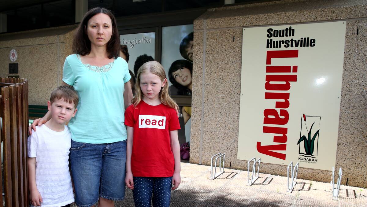Karina McDougall and her children Ashleigh, 8, and Adam, 6, at the South Hurstville Library which has reopened with altered hours. Picture: Geoff Jones.