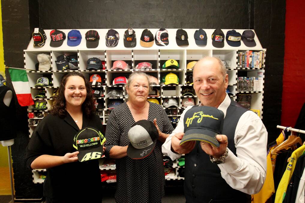 Patrick Wedes (right) with wife Deb and daughter Myanna (left) at their South Hurstville Motorsport Shop, which is closing after 30 years. Picture: Chris Lane