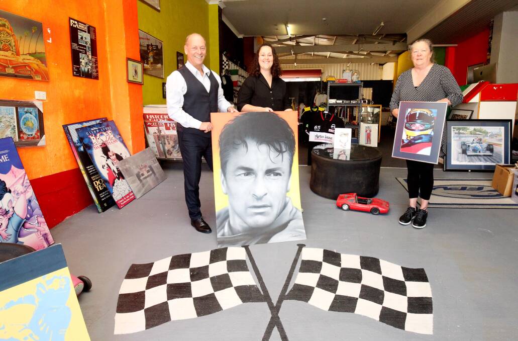Patrick Wedes with daughter Myanna and wife Deb with some of the stock still to be sold at their South Hurstville Motorsport Shop. Picture: Chris Lane