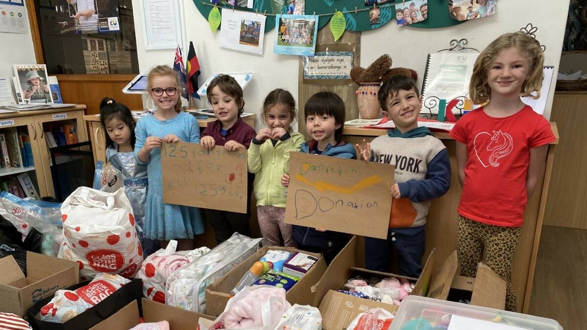 Charity drive: KU Sutherland kids collect donations which will go to local families and children in need through the Dandelion Support Network. Picture: Supplied