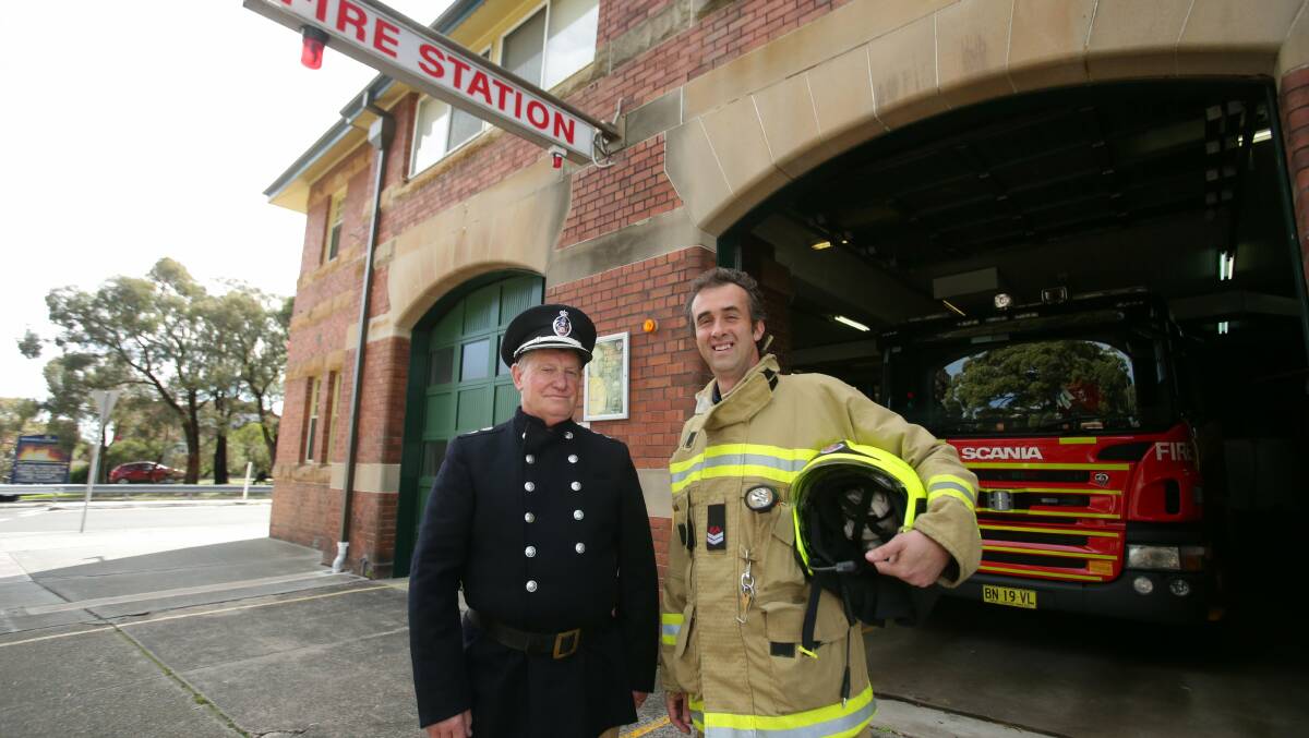 Past and present: Bob Gouttman and Paul Dunn show the changing fire uniforms. Picture: Chris Lane
