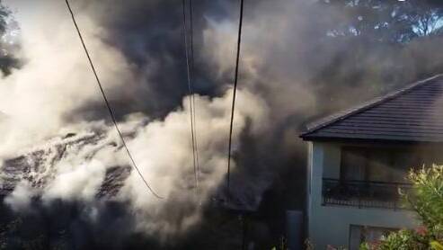 Blaze: Smoke billows from a house at Kareela on Sunday. Picture: Supplied