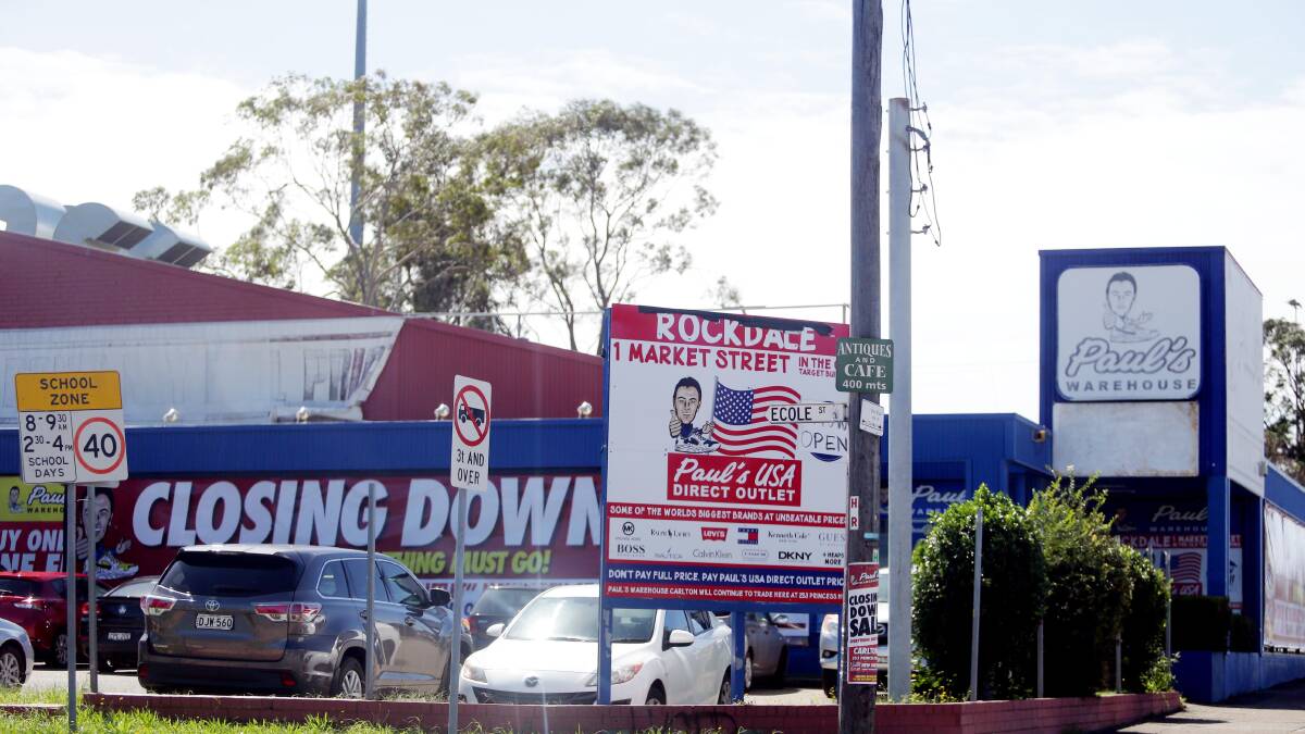 End of an era: Closing down signs cover the Paul's Warehouse store in Carlton. Picture: Chris Lane