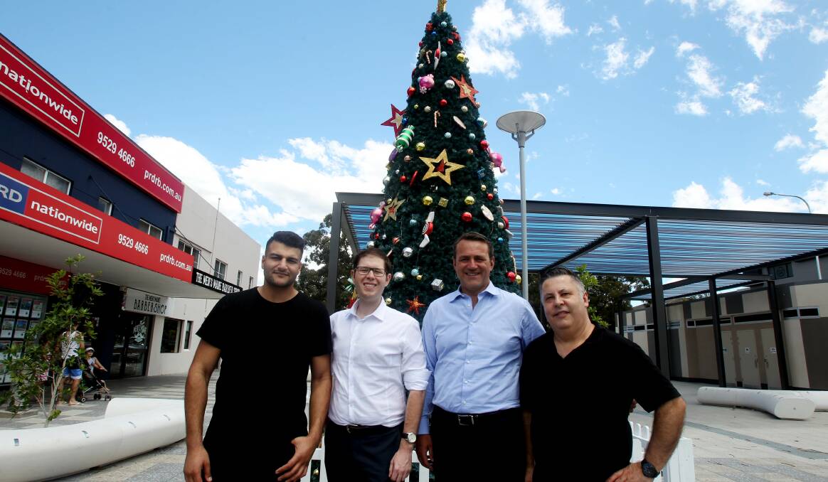 Christmas cheer: Jonah Geries from Cafe Figaro, Bayside Councillor Ed McDougall, Member for Rockdale Steve Kamper and George Mourlas from Chicken Ace. Picture: Chris Lane