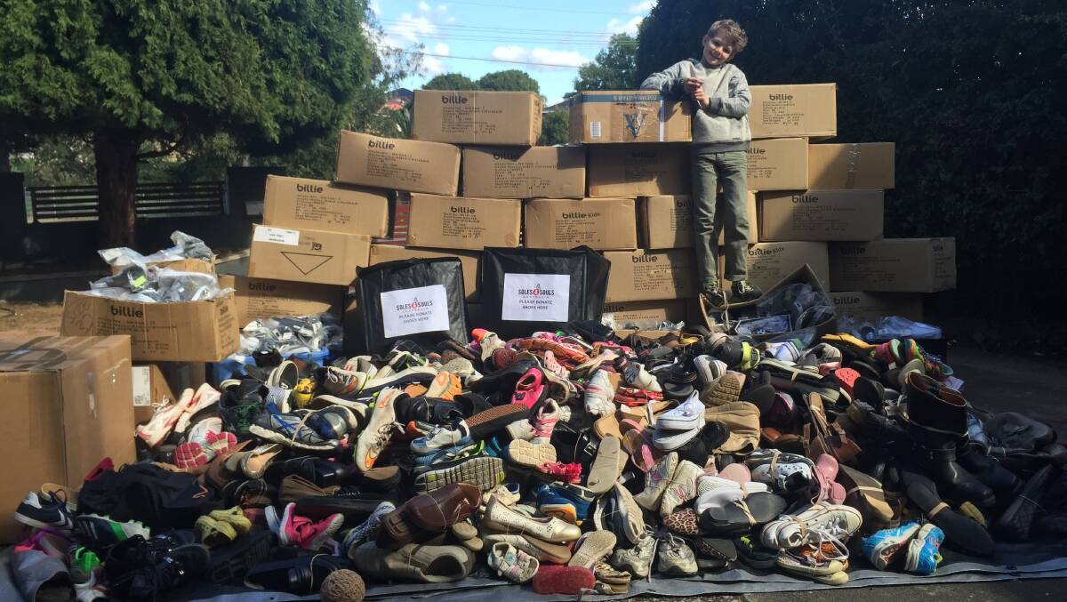 Fundraising superstar: Leo Berry, 10, with the shoes he has collected. Picture:Supplied