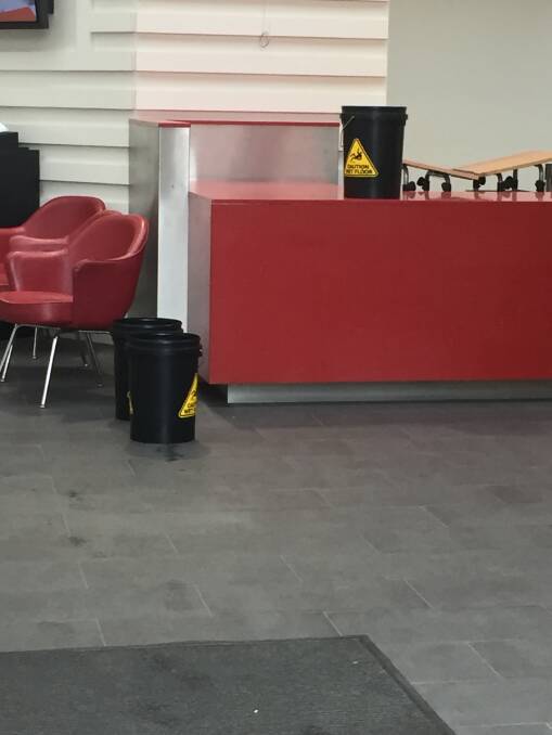 Library leaks: Black buckets collected water leaking through the Kogarah Library roof on Monday.