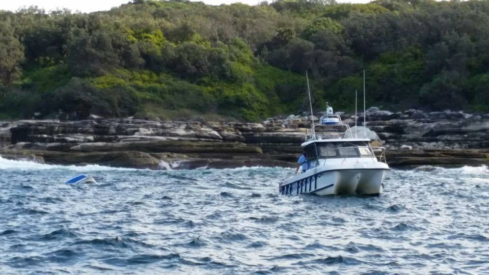 Rescue: Marine Rescue respond to a boat overturned at Cape Solander. Picture: Marine Rescue NSW