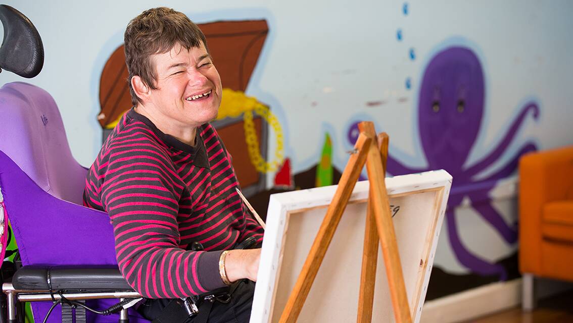 Picture perfect: A Sylvanvale customer painting in the Art with Heart program. Picture: Supplied