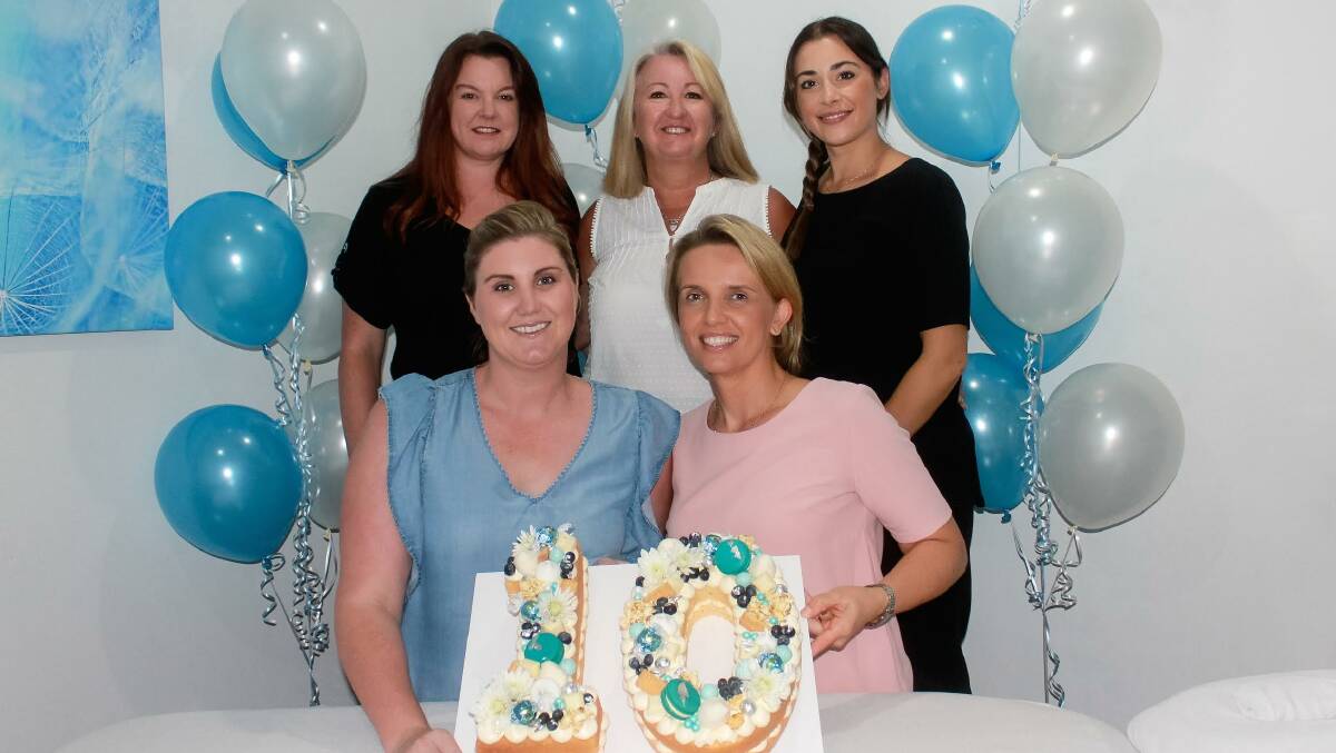 Time to celebrate: With a cake made by Loren Gittoes at Sprinkles and Cream, Sutherland Osteopathy celebrate 10 years in business. Pictured Natalie Ross, Lea Tsekouras, and Natalie Challinor, Nicole Rogers and Kerrin Murnane.