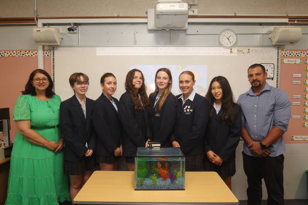 Georges River College Peakhurst students Lillian King, Abigail McKenzie, Amelia Wilson, Tahlia Coulton, Abbie Clay and Mya Wong with Principal Diane Wilson and teacher Ahmad Bousaleh. Students were required to create a one-minute video and worked collaboratively to write a report detailing their idea for mechanically driven artificial upwelling. Picture by Chris Lane
