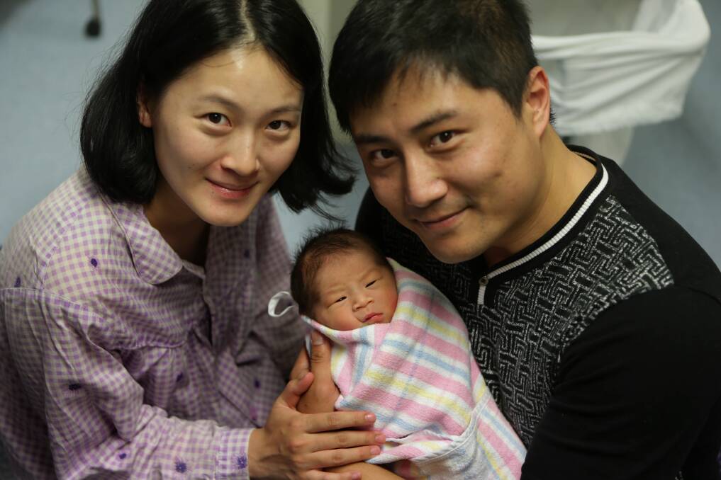 Top timing: Ronny Li (pictured right) with his wife Qing Du and their new baby boy, Tory, born on Father's Day. Picture: John Veage