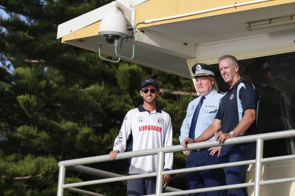 Beach watch: NSW Police State emergency operations controller, deputy commissioner Jeff Loy, and chief executive of Surf Lifsaving NSW, Steven Pearce with a Sutherland Shire lifeguard at North Cronulla. Picture: John Veage