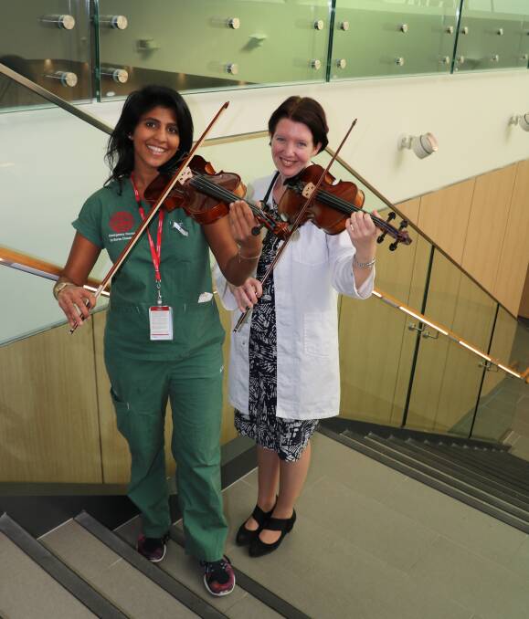 Performing a different role: St George Hospital's emergency registrar Sarasvati Chauhan and geriatrician Louise Baird will play the violin and at this year's NSW Doctor's Orchestra concert.