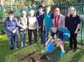 Royal plant: Caringbah Garden Club representatives, Helen Kerr, Barbara Binns and June Robinson with students from Minerva School plant a tree for the Queen's Jubilee.