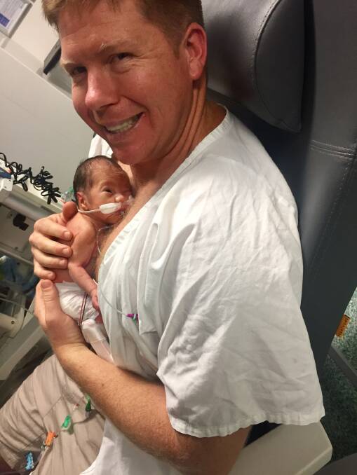 Mr Mulhern holds his son shortly after birth.