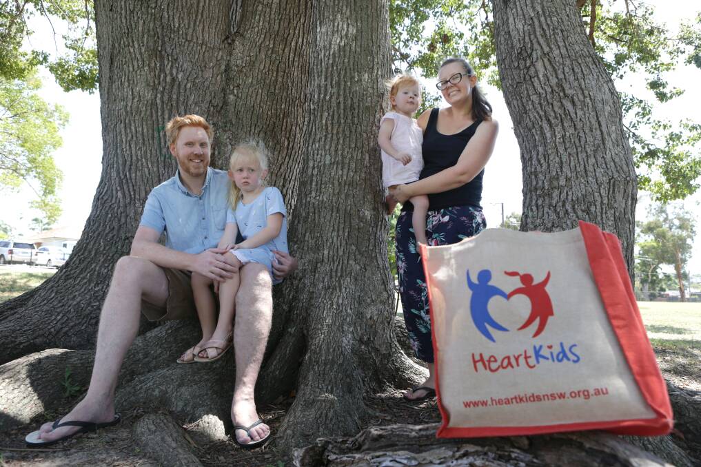 The shape of love: Luke and Aimee Baglin with their daughters Aria, and Eva, who was born with a rare heart disease. Picture: John Veage