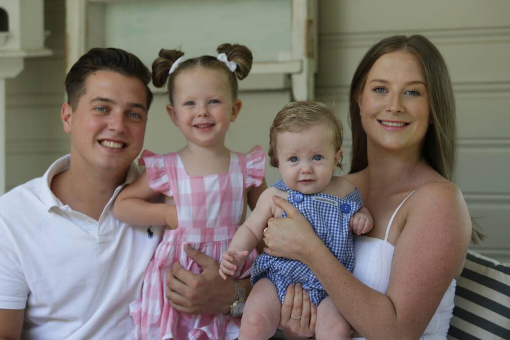 Promising move: Harvey, 10 months of age, could soon benefit from cystic fibrosis treatment that has been recently added to the PBS. Pictured are his parents Cameron Miller and Annie Smith, with their daughter Scarlett. Picture: John Veage