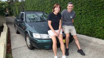 Fiona and Mick Briggs of Caringbah South bought a 25 year-old Toyota Camry for $100 ahead of their outback drive for a cancer fundraiser in the 'Shitbox Rally'. Picture by Chris Lane