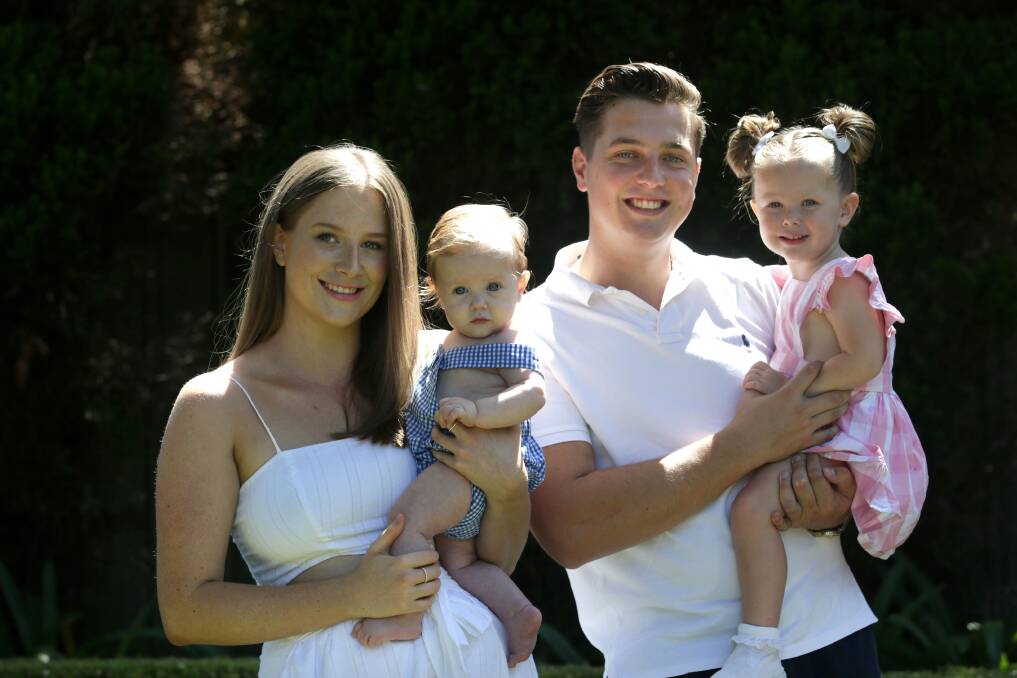 Heartbreak behind a smile: Annie Smith and partner Cameron Miller with their daughter Scarlett, and baby son Harvey, who has cystic fibrosis. Picture: John Veage