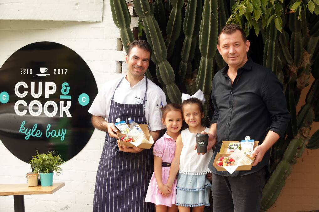 Lunch on the go: Cup & Cook Kyle Bay co-owners Matthew Oxenham and Charles Dimarco, who is also the chef, with Francesca Maiolo and Elise Bosco, both 5. Picture: Chris Lane
