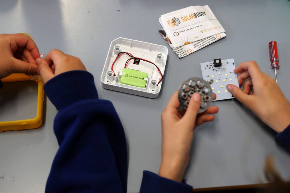 Pupils put together their solar-powered lights. Picture: John Veage