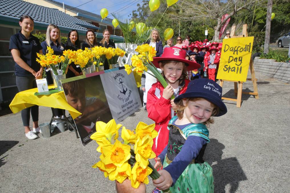 A generous bunch: Sisters Zoe, 6, and Ava, 3 join in a yellow celebration for Daffodil Day. Picture: John Veage