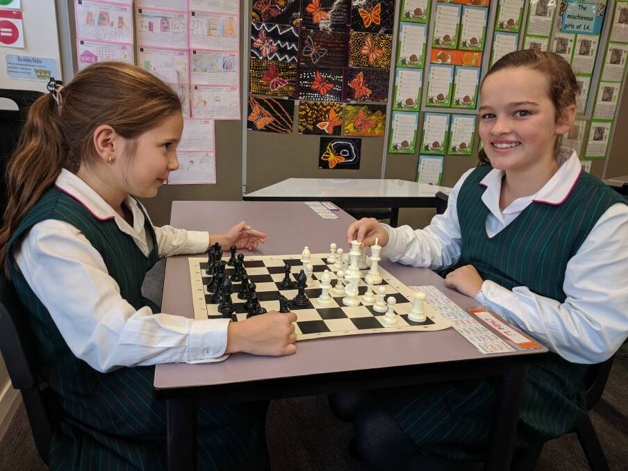 Game skills: Anjelica Bevacqua, 8, and Sienna McNamara, 10, get into a game of chess.