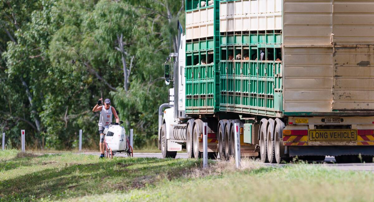 G'day: Jones waves to a passing truck driver. Picture: G Digital Media