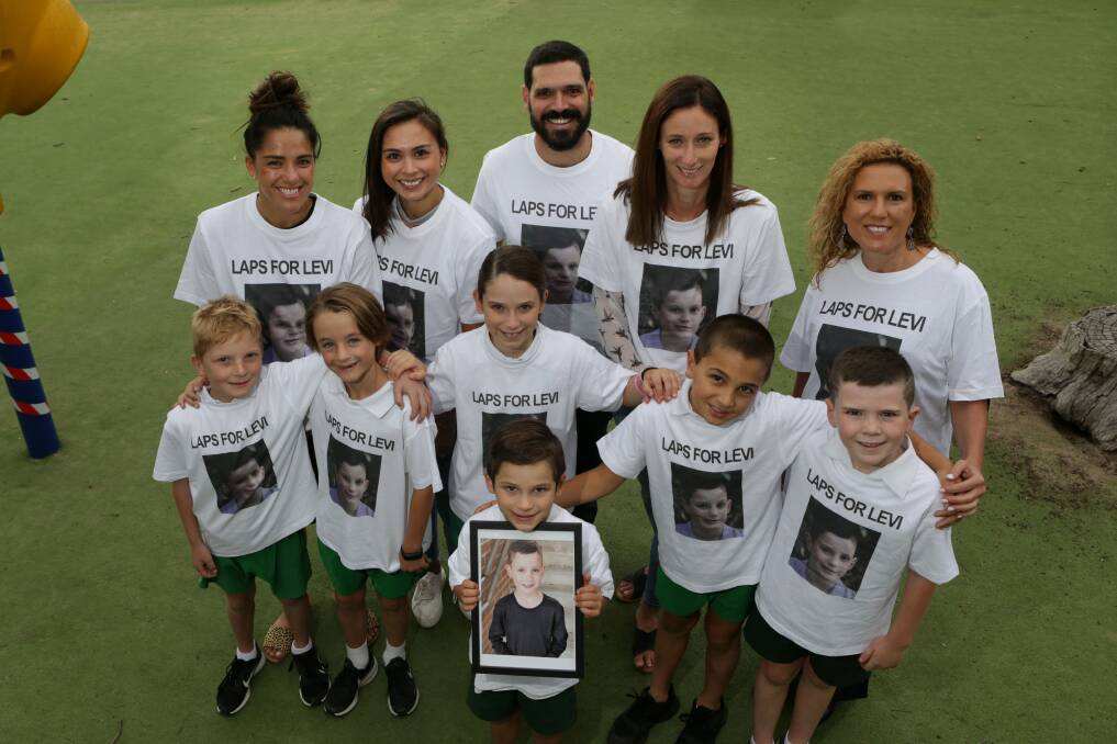 School support: Levi's family joins arm in arm with Burraneer Bay Public School staff, pupils and some of Levi's best friends, who will do 'laps for Levi' at the relay. Picture: John Veage