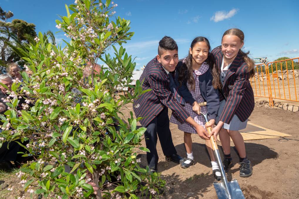 Marking future growth: Marist Catholic College Penshurst students Jacob Khoury and Isabella Felici with St Joseph’s Oatley student Aya Macapagal (centre) at a tree planting ceremony for the college’s new campus.