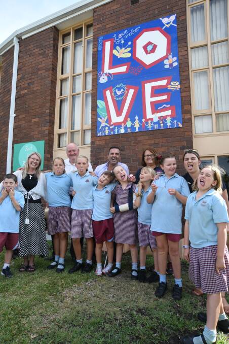 Sutherland Shire Council mayor Carmelo Pesce attends the opening of a new community space at Engadine Uniting Church with pupils from Engadine Public School. 