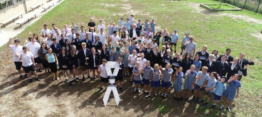 A drone captures students uniting for White Ribbon Day.