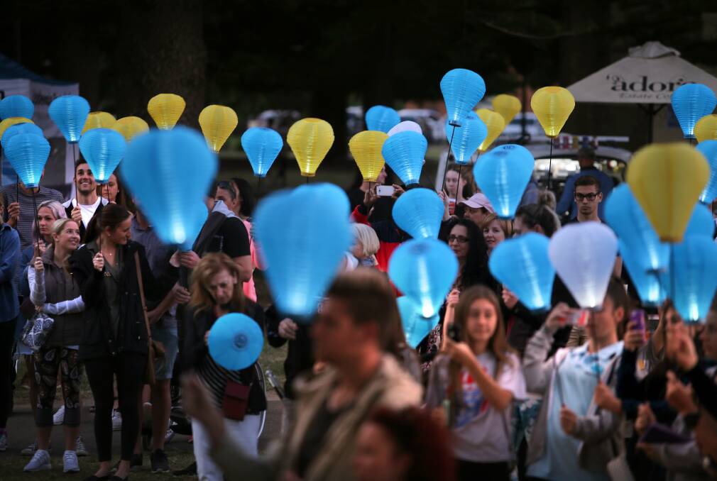 Colours of hope: From a lantern raising ceremony at Dunningham Park to a dusk walk along the Esplanade, a generous community gathers in unity. Picture: John Veage