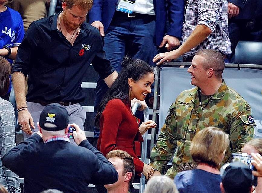 A step up from the classroom: Bundeena's Kahn Bungate guards the Duke and Duchess of Sussex at the Invictus Games during a Sydney tour. The photo 