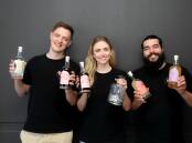 Founders of Scylla Distilling Co, John and Zoe Williams with Justin Atic with their award winning raspberry liqueur, made at Taren Point. Picture by Chris Lane
