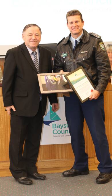 Bayside Council mayor Bill Saravinovski presents Superintendent Julian Griffiths with a Certificate of Recognition, thanking him for his service to the community.