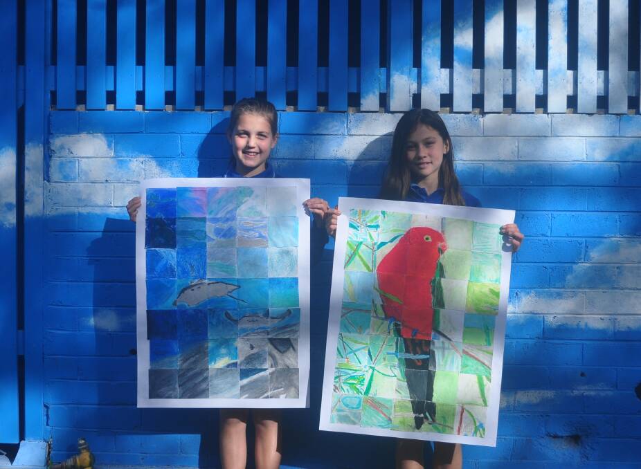 Oceanic blues: Bundeena Public School pupils proudly display some of the artworks that will feature in a community art exhibition on Saturday and Sunday, July 27 and 28. 