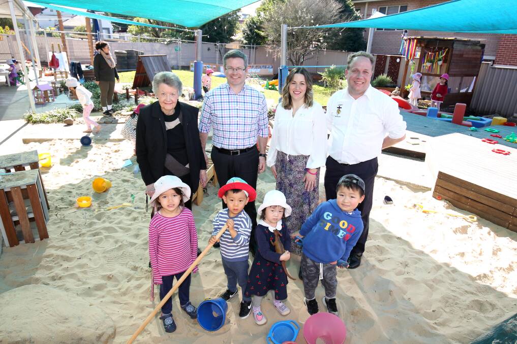 Fifty years on: Betty Dayes, Oatley MP Mark Coure, Kindergarten director Alex Tsanidis and church rector Peter Greenwood, with children Eleanor, Albert, Kate and Immanuel. Picture: Chris Lane