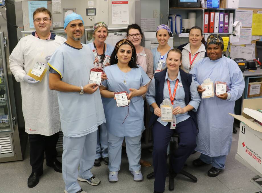 Operation of giving: St George Hospital staff have contributed solid blood donations as part of an Australian Red Cross campaign, National Health Services Challenge. Some of the donors from the operating theatre are pictured with Blood and Blood Products clinical nurse consultant, Samantha Connelly (front, second from right).
