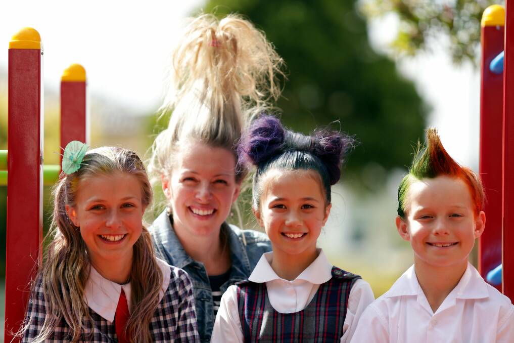 Hair play: Tara Napper, Charlotte Mariano and Asher Maunz, with their teacher Noelle Buhagiar, go crazy for a worthy cause. Picture: Chris Lane 