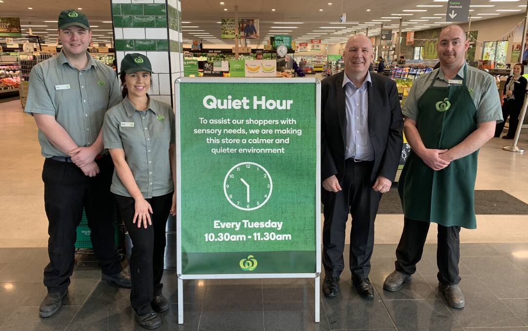 Quiet time: Life Without Barriers executive lead Chris Chippendale (second from right) with Woolworths staff. Three stores in St George and Sutherland Shire will aim to reduce noise for customers for one hour each week.