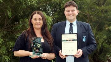 Tharawal Public School teacher Kirsty Adams and The Jannali High School captain Max McKimm with their awards for excellence in Aboriginal education. Picture by Chris Lane