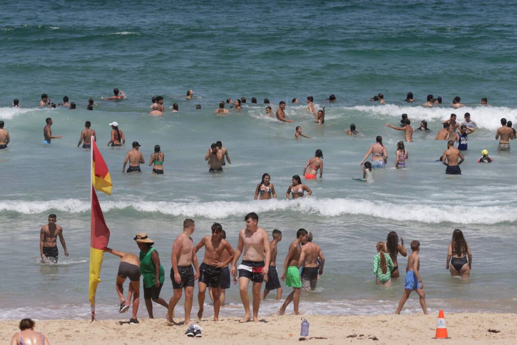 Sand swarm: North Cronulla has been packed every day so far this week. Picture: John Veage