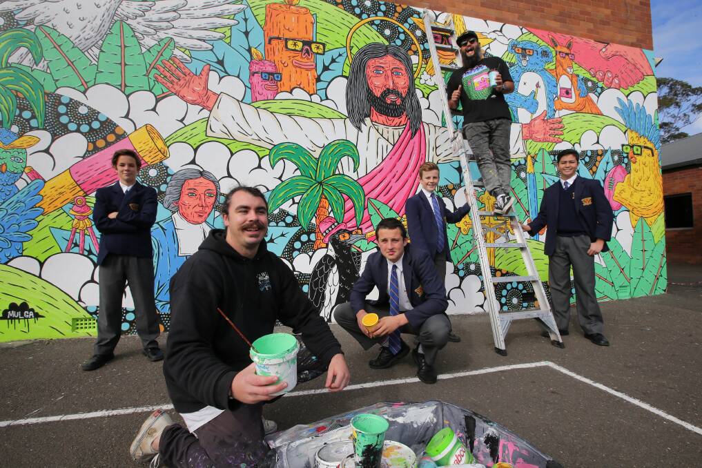 That's a wrap: Artists Zachary Bennett Brook and Joel 'Mulga' Moore and students from De La Salle Catholic College Caringbah together worked in this school mural. Picture: John Veage