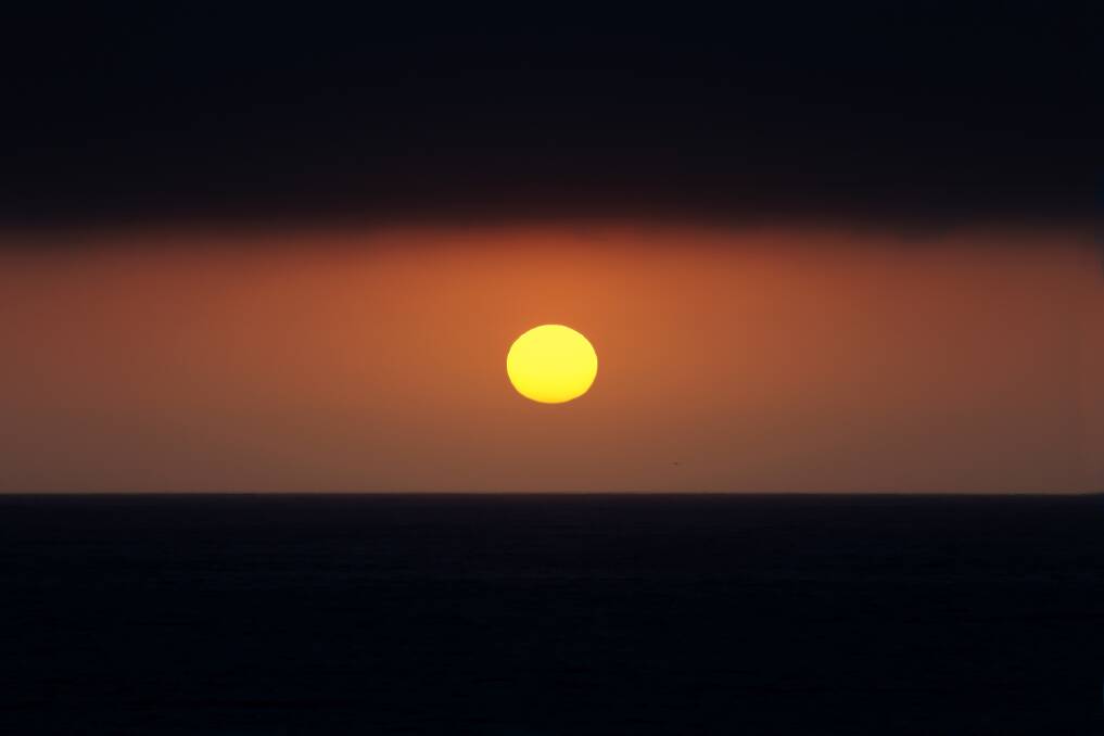 Fried like an egg: Friday morning's sunrise heats up over North Cronulla. Picture: John Veage