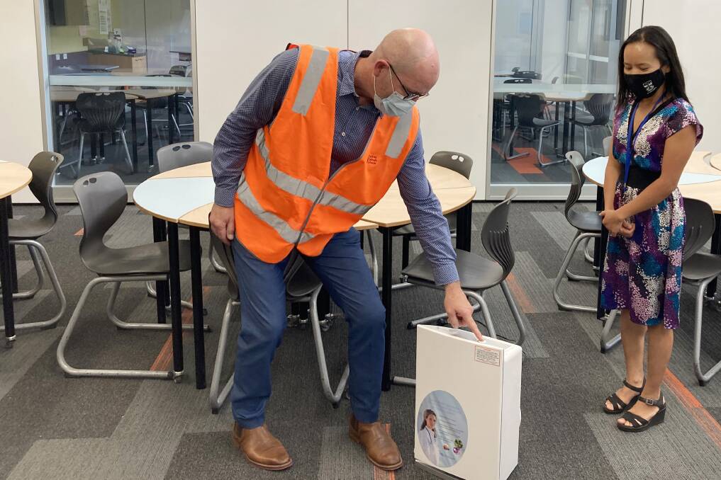 Cleaner classrooms: Sydney Catholic Schools' minor capital works specialist Daniel Conroy and St Ursula's College Kingsgrove's Business Manager Claire Baroni with one of the new air purification units. 